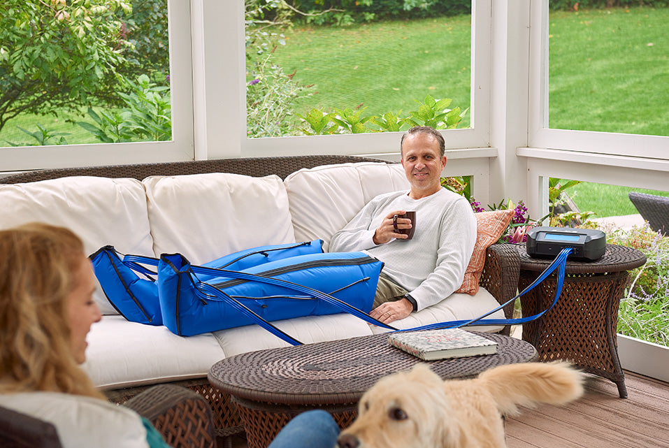 Athlete using Bio Compression sequential compression boots at home, showing the best compression boots for athletes for post-workout recovery.
