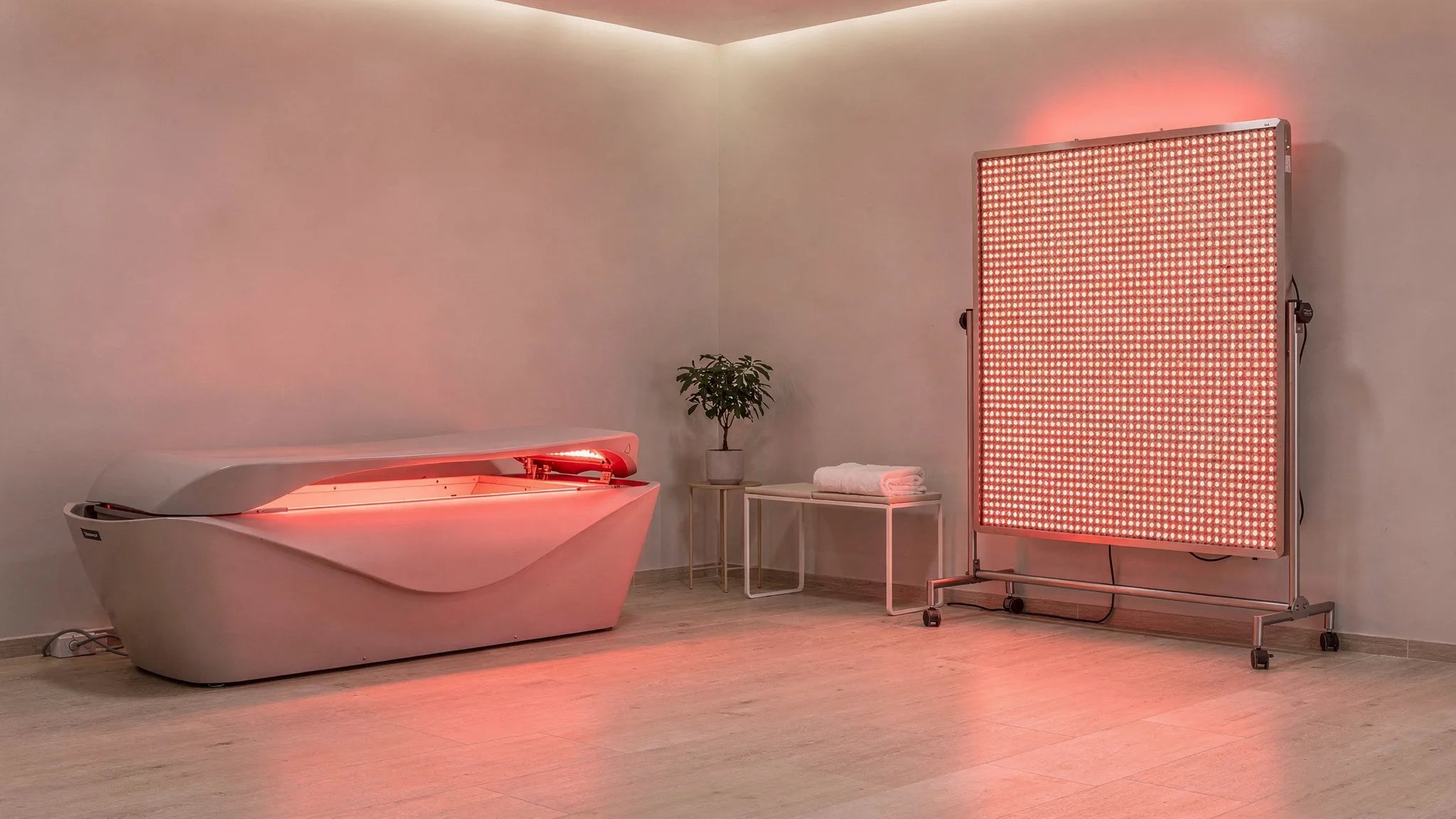 Home wellness room comparing a red light bed vs panel setup side by side showing the form factor differences relevant to this red light bed vs panel review