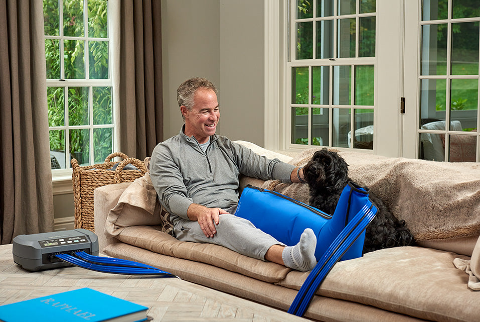 Traveler managing travel swelling in legs prevention tips with a medical-grade pneumatic compression device.